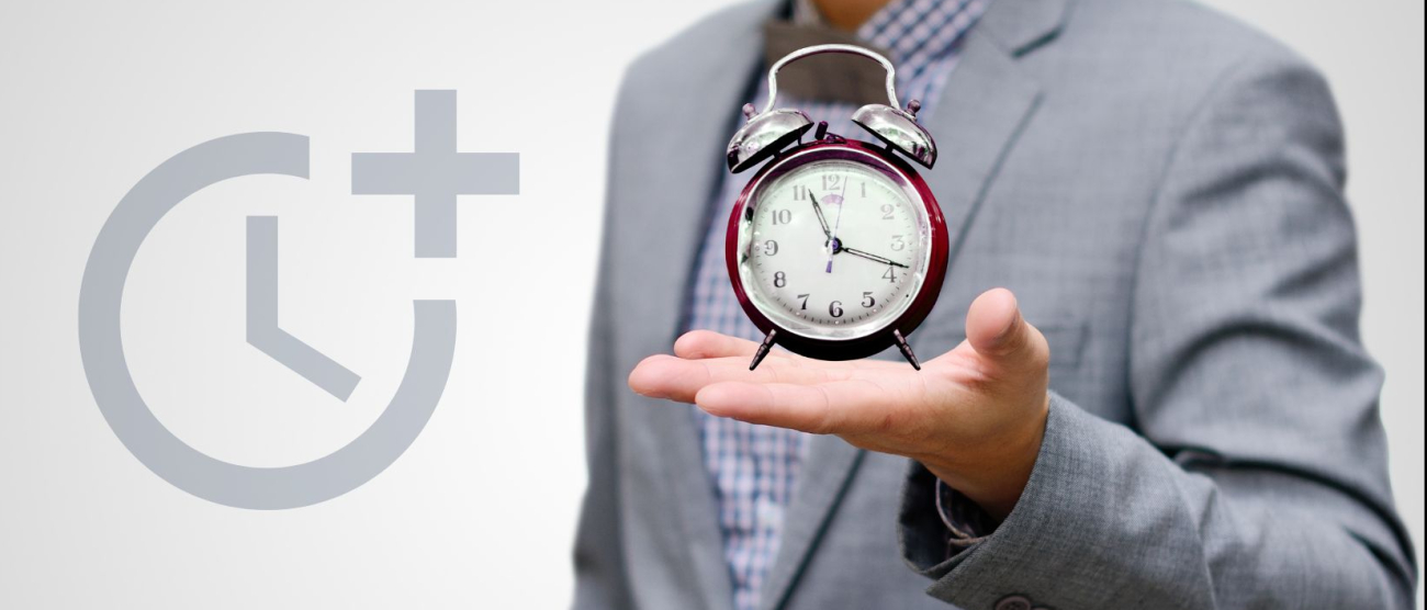 mężczyzna trzymający w dłoni budzik